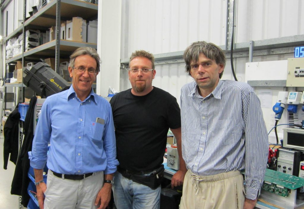 Antonio Cazzaniga of ONVIDEO, Luca Romani of Movie People on a factory tour, with graduate test engineer, Trevor Randle of Power Gems