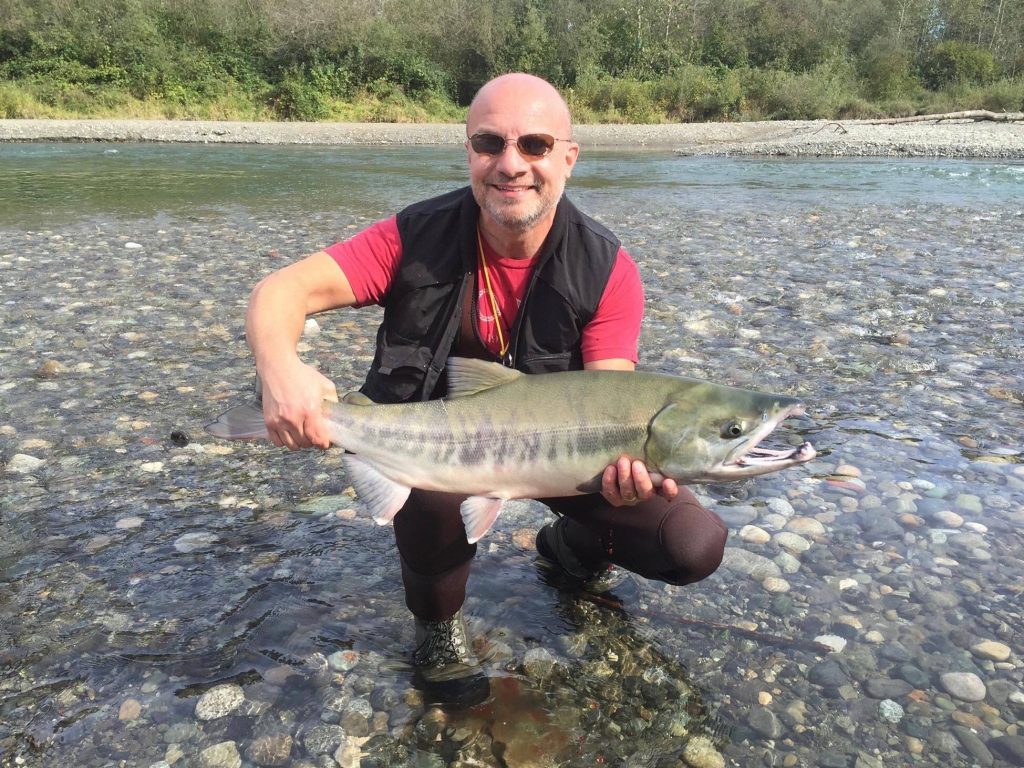 Jeremy Walsh holding a salmon on Vancouver Island